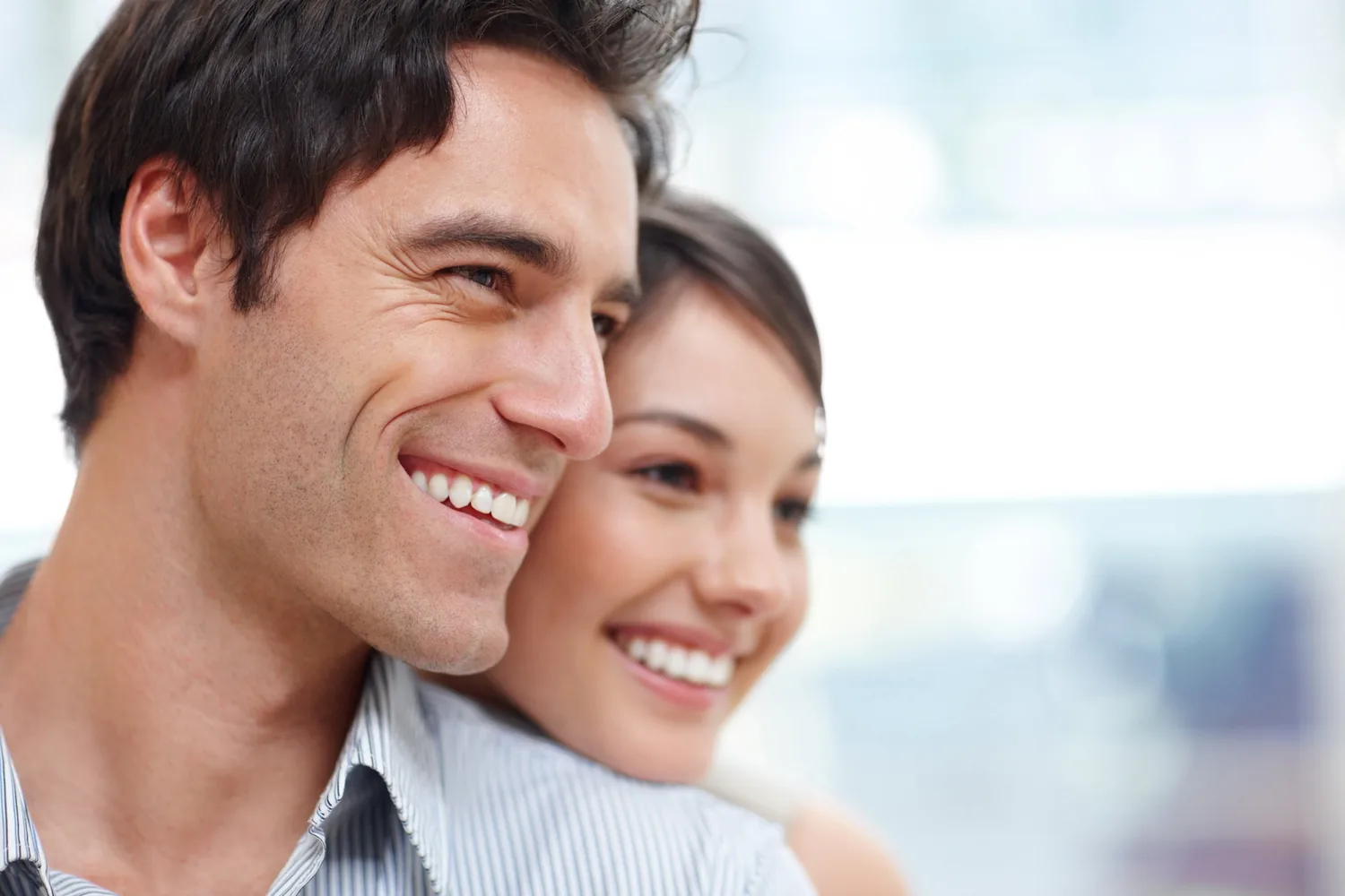 A couple smiling after a dental visit